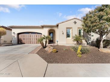 Single-story home with brown garage door, landscaping, and desert plants at 122 E Orange Blossom Path, Queen Creek, AZ 85140