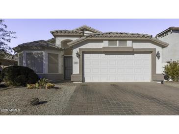 White one-story house with a two-car garage and landscaped front yard at 1374 E Kingman Pl, Casa Grande, AZ 85122