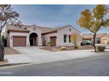 Single-story home with two-car garage and desert landscaping at 21556 S 215Th Pl, Queen Creek, AZ 85142