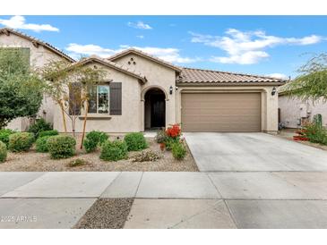 Single-story home with a two-car garage and well-manicured landscaping at 25422 S 228Th St, Queen Creek, AZ 85142