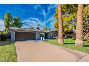 Contemporary home with gray exterior, two-car garage, and landscaped yard at 2942 N 81St Pl, Scottsdale, AZ 85251