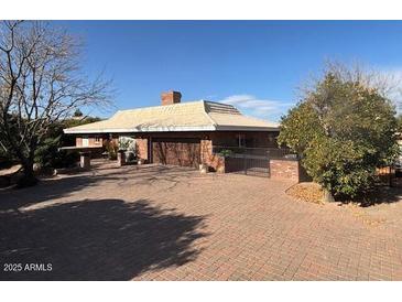 Brick ranch house with attached garage and large driveway at 4024 E Hermosa Vista Dr, Mesa, AZ 85215