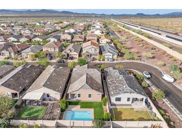 Aerial view of a community with houses, roads, and a highway at 4125 W Bradshaw Creek Ln, New River, AZ 85087