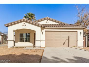 Newly constructed home with a two-car garage and neutral color palette at 414 E Eason Ave, Buckeye, AZ 85326