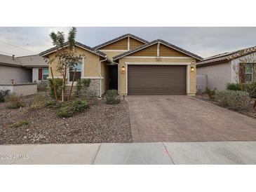 One-story home with a brown garage door and landscaped front yard at 4524 S 127Th Ln, Avondale, AZ 85323