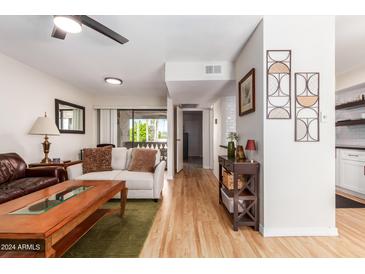 Bright living room with hardwood floors, comfy sofas, and a coffee table at 4950 N Miller Rd # 347, Scottsdale, AZ 85251