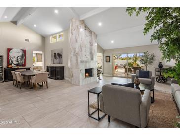 Spacious living room with fireplace and large windows at 5660 N 73Rd St, Scottsdale, AZ 85250