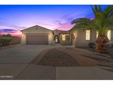 Beautiful desert home exterior at sunset, featuring a welcoming entryway and landscaping at 6616 S Bridal Vail Dr, Gilbert, AZ 85298