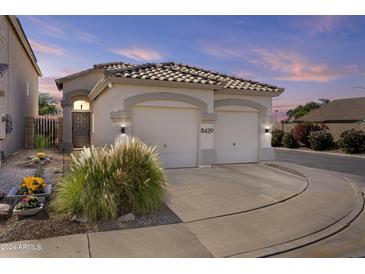 Two-car garage, desert landscaping, and a charming curb appeal at 8429 W Salter Dr, Peoria, AZ 85382