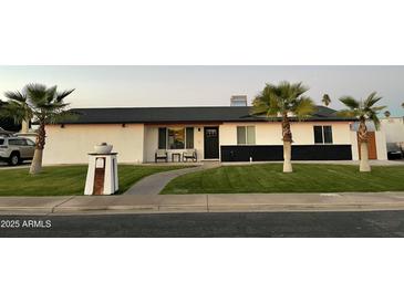 Remodeled mid-century modern home with a landscaped front yard at 920 E 10Th Pl, Mesa, AZ 85203