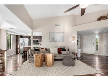 Bright living room with hardwood floors, comfy seating, and a view into the kitchen at 9305 E Purdue Ave # 265, Scottsdale, AZ 85258