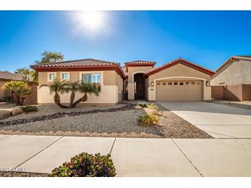 Single-story home with desert landscaping and two-car garage at 16581 W Washington St, Goodyear, AZ 85338