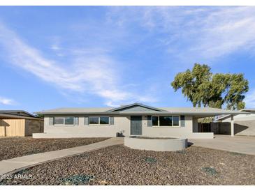 Newly renovated single story home with landscaped front yard and walkway at 310 W Aspen Ave, Gilbert, AZ 85233