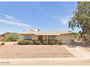 Ranch style home with a carport and well-manicured front yard at 10546 W Catalina Dr, Arizona City, AZ 85123