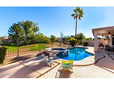 Large backyard pool with patio and lounge chairs at 1269 N Layman St, Gilbert, AZ 85233