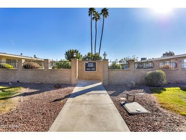 Front view of a light beige building with a walkway and landscaping at 13635 N 111Th Ave, Sun City, AZ 85351