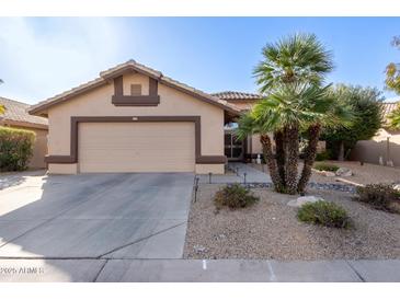 Single-story home with a two-car garage and desert landscaping at 14215 W Mountain Laurel Trl, Surprise, AZ 85374