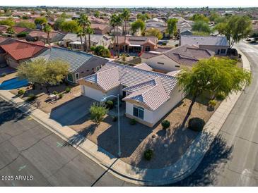 Single-story home with tile roof, desert landscaping, and a corner lot location at 15437 W Domingo Ln, Sun City West, AZ 85375