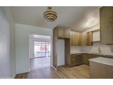 Modern kitchen with wood cabinets, quartz countertops, and stainless steel appliances at 1918 W Colter St, Phoenix, AZ 85015