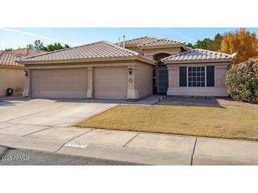 Two-story house with a three-car garage and landscaped yard at 21918 N 66Th Ln, Glendale, AZ 85310