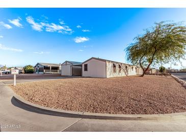 Single-wide manufactured home with a carport and gravel landscaping at 2881 W Cactus Wren St, Apache Junction, AZ 85120