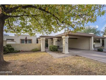 Single-level home with carport and landscaped front yard at 2911 W Lamar Rd, Phoenix, AZ 85017