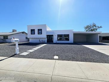 Charming single-story home with a modern exterior, black rock landscaping, and an attached carport at 3447 W Dailey St, Phoenix, AZ 85053