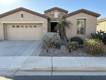 Tan two-story house with brown roof, landscaping, and a two-car garage at 4531 E Jude Ln, Gilbert, AZ 85298