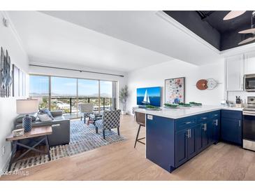 Open living area with city views, hardwood floors, and stylish furnishings at 4750 N Central Ave # N16, Phoenix, AZ 85012