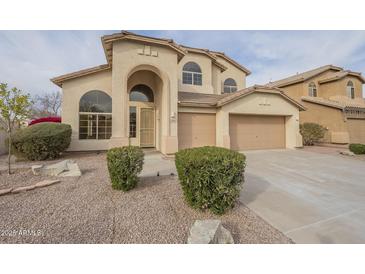 Two-story house with beige exterior, landscaped yard, and two-car garage at 532 N Bell Dr, Chandler, AZ 85225