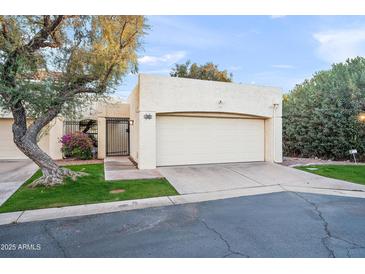 Tan stucco home with a two-car garage and well-maintained landscaping at 5711 N 24Th Pl, Phoenix, AZ 85016