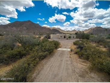 Aerial view of a sprawling desert property with a large house and private pool at 5713 W Sun Dance Dr, San Tan Valley, AZ 85144