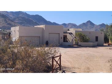 Inviting desert home with two-car garage, arched gated entrance, and mountain views at 5713 W Sun Dance Dr, Queen Creek, AZ 85144