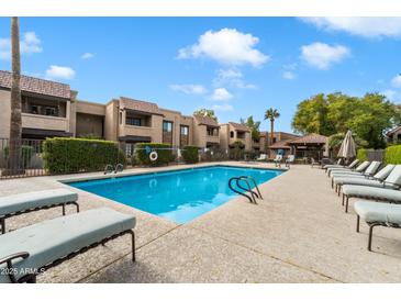 Inviting community pool with lounge chairs and shaded seating area at 5995 N 78Th St # 1015, Scottsdale, AZ 85250