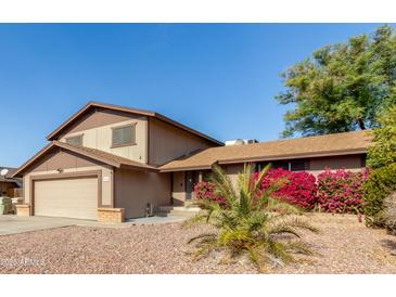 Attractive two-story house with a landscaped yard and two-car garage at 6046 W Carol Ann Way, Glendale, AZ 85306