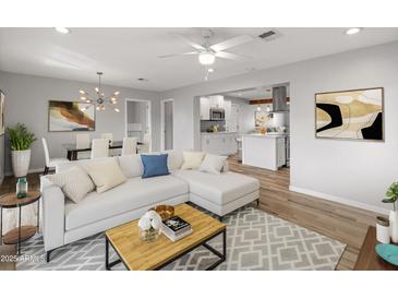 Bright living room with open floor plan, hardwood floors, and modern furniture at 7443 E Taylor St, Scottsdale, AZ 85257