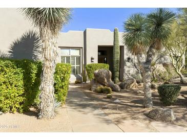 Stone pathway leads to the entrance of this Southwestern style home at 9580 E Southwind Ln, Scottsdale, AZ 85262