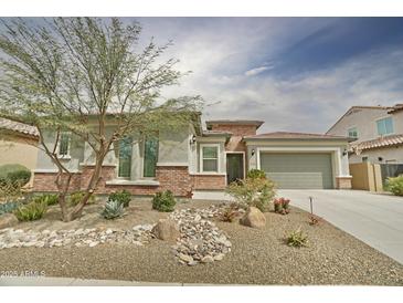 Charming single-story home showcasing desert landscaping, a two-car garage, and a brick facade, creating inviting curb appeal at 1536 W Blaylock Dr, Phoenix, AZ 85085