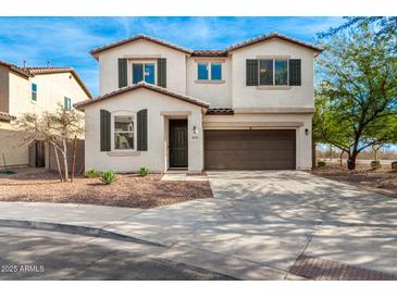 Two-story house with brown garage door and landscaping at 1649 N 212Th Dr, Buckeye, AZ 85396