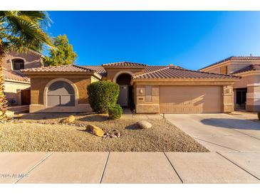 Single-story home with tile roof, desert landscaping, and two-car garage at 16831 S 14Th Ln, Phoenix, AZ 85045