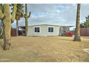 Single-wide manufactured home with desert landscaping and a gray exterior at 2191 S Descanso Rd, Apache Junction, AZ 85119