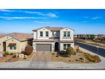 Two-story house with gray garage door and landscaping at 22413 N 101St Ave, Peoria, AZ 85383