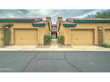 Tan stucco building with multiple garages and a walkway at 225 W 1St St # 118, Mesa, AZ 85201