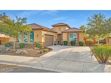 Beautiful one-story home with a three-car garage and well-manicured landscaping at 26119 W Wahalla Ln, Buckeye, AZ 85396