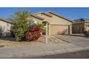 Single-story home with tan exterior, attached garage, and landscaping at 2838 W Apollo Rd, Phoenix, AZ 85041