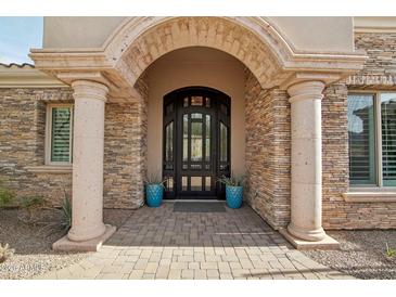 Elegant entryway with arched detail and a large custom door at 34157 N Mirage Ct, San Tan Valley, AZ 85144