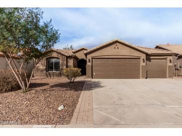 Single-story home with three-car garage and landscaped front yard at 3718 E Elmington Cir, San Tan Valley, AZ 85140