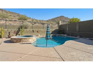 Inviting kidney-shaped pool with spa and mountain views at 38213 N Raleigh Way, Anthem, AZ 85086