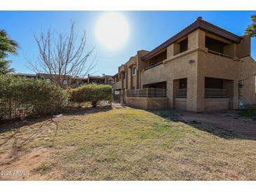 Exterior view of a two-story building with a grassy yard at 4050 E Cactus Rd # 201, Phoenix, AZ 85032