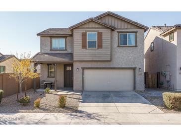 Two-story house with gray siding, attached garage, and landscaping at 416 N 110Th Ave, Avondale, AZ 85323